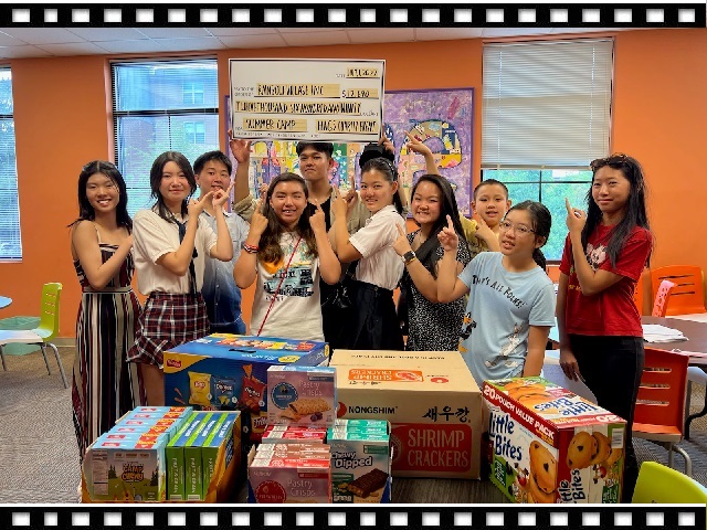 Youth volunteers present donated snacks and a $12,690 summer camp donation to Rainbow Village following the 2022 Have A Great Summer charity event.